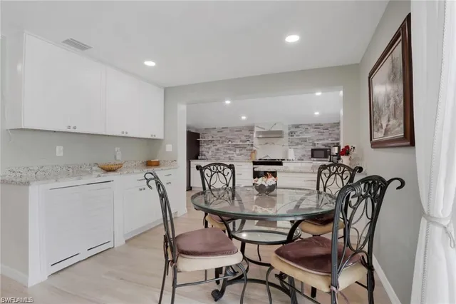 a dining room with furniture and a floor to ceiling window