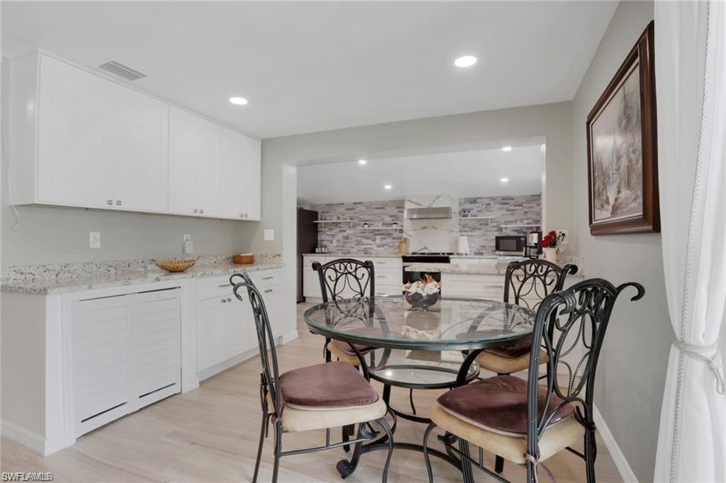 829 107th Avenue North Naples, FL 34108 - Photo 4 of 34 a dining room with furniture and a floor to ceiling window