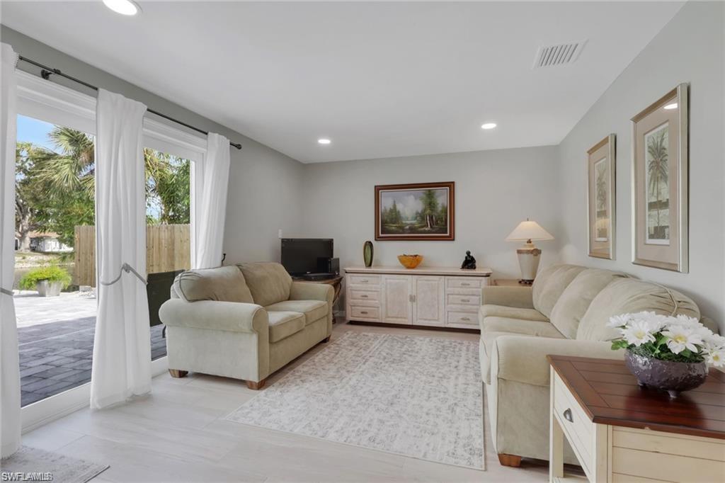 829 107th Avenue North Naples, FL 34108 - Photo 5 of 34 a living room with furniture and a large window