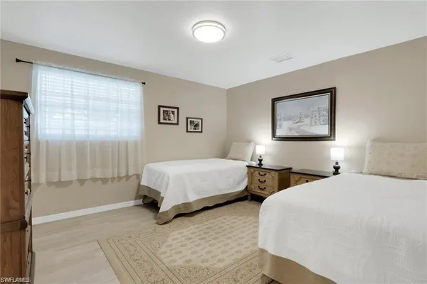 a bedroom with two beds and a window