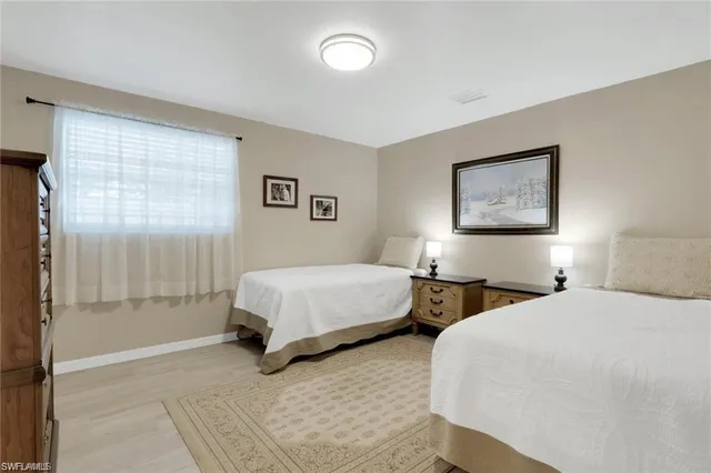 a bedroom with two beds and a window