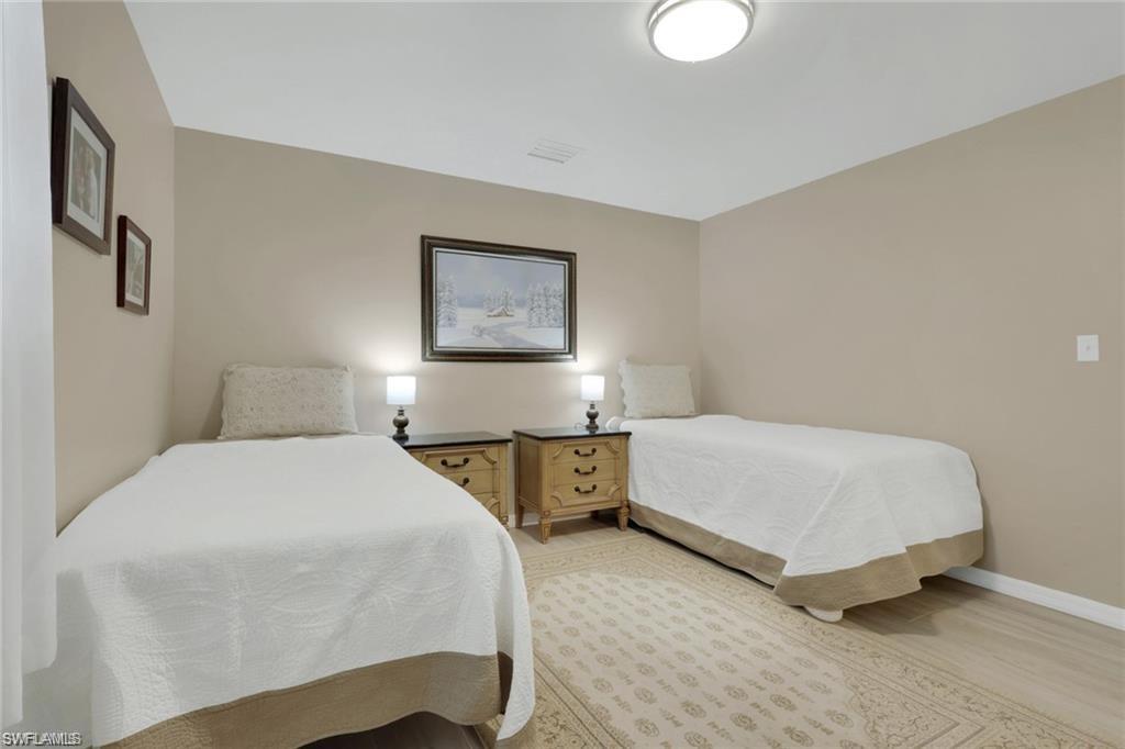 829 107th Avenue North Naples, FL 34108 - Photo 10 of 34 a bedroom with a bed and two lamp