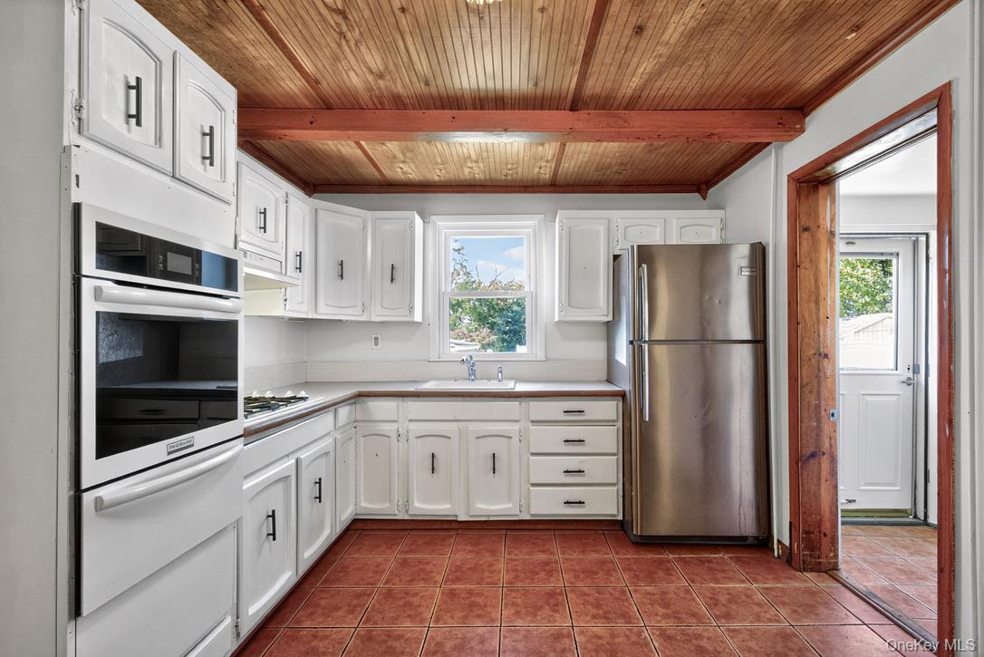 15 Paye Avenue Beacon, NY 12508 - Photo 16 of 36 a kitchen with granite countertop a refrigerator and a stove top oven