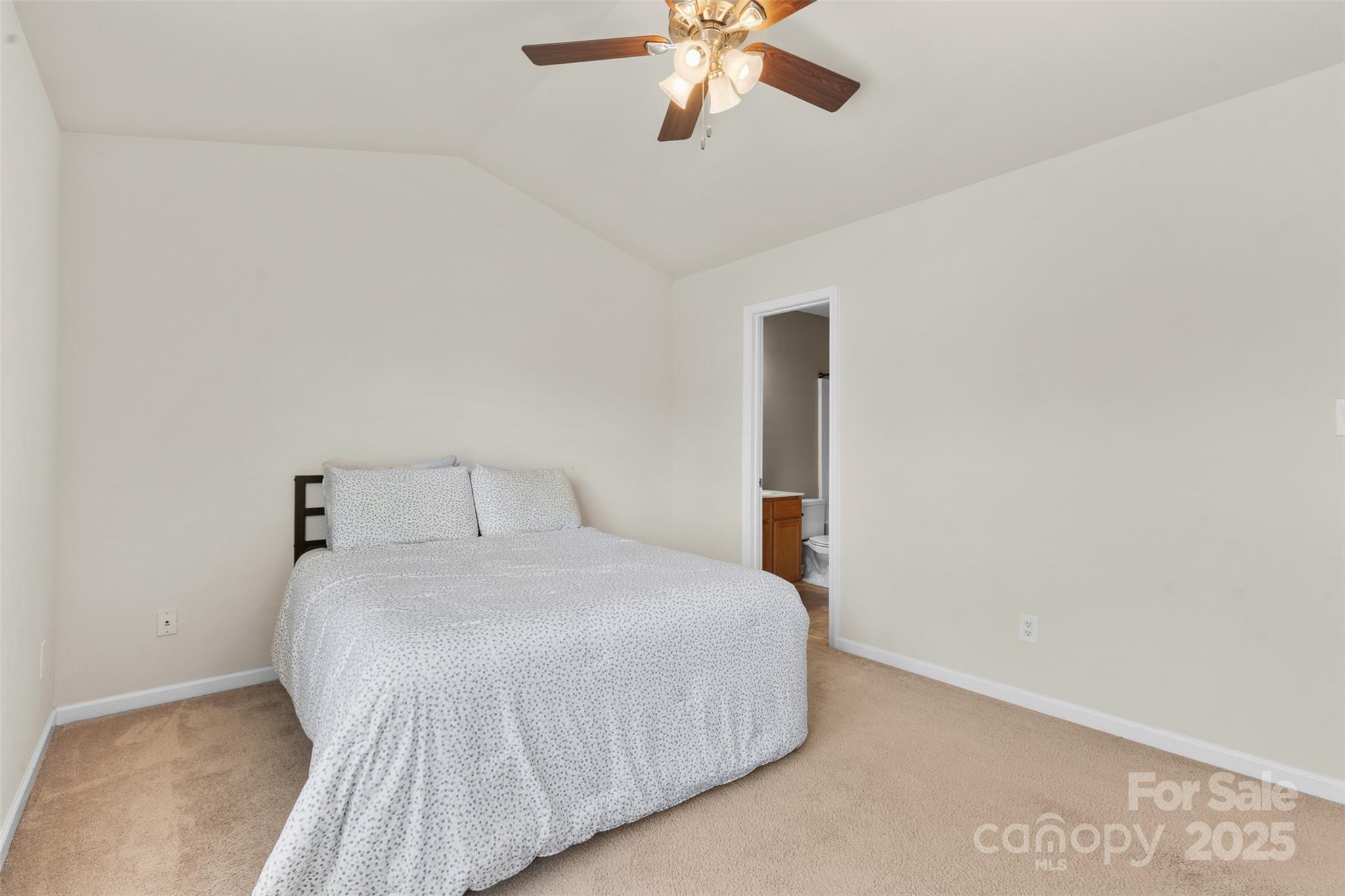 6320 Rhodins Lane Fort Mill, SC 29707 - Photo 14 of 33 a bedroom with a bed and a chandelier