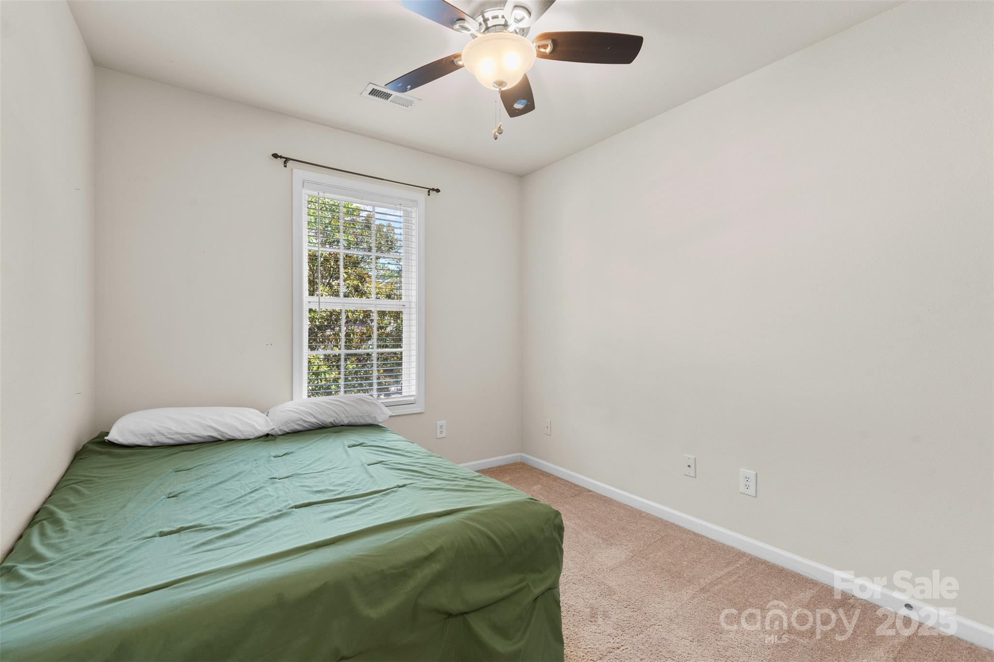 6320 Rhodins Lane Fort Mill, SC 29707 - Photo 20 of 33 a bedroom with a bed and a chandelier