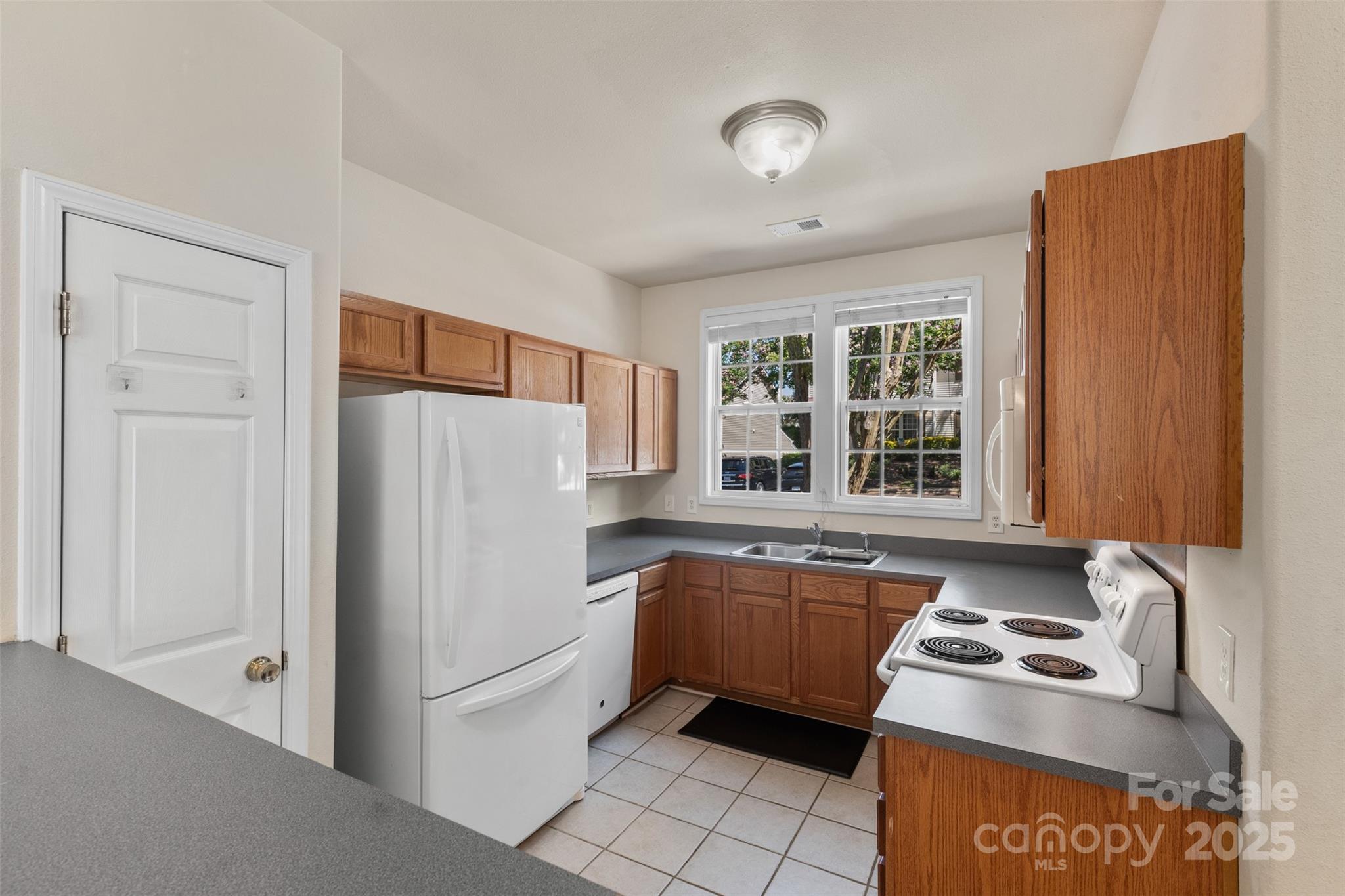 6320 Rhodins Lane Fort Mill, SC 29707 - Photo 4 of 33 a kitchen with stainless steel appliances granite countertop a refrigerator and a sink