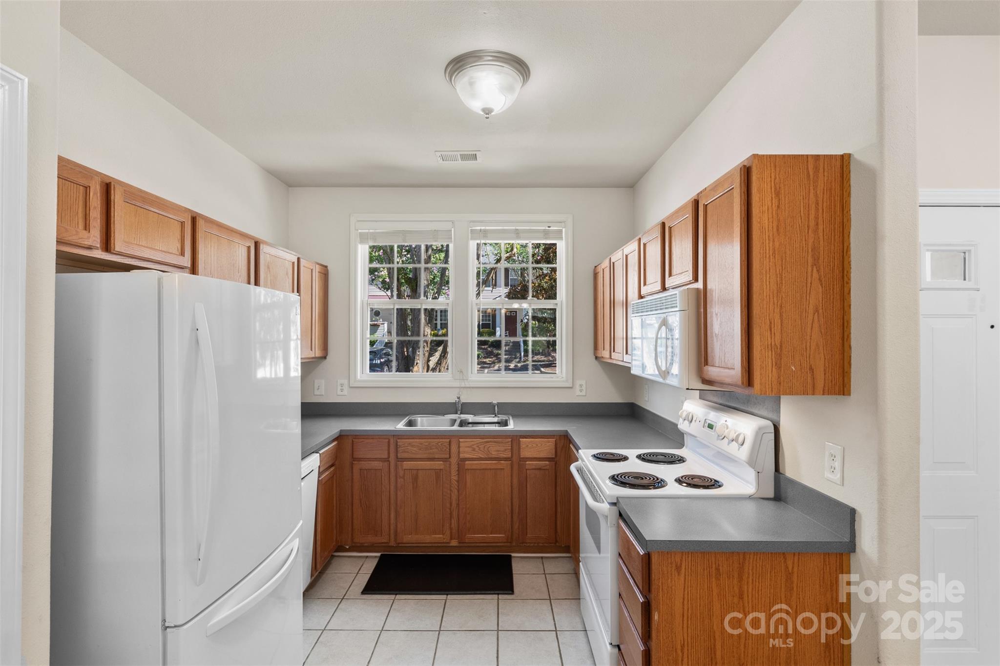6320 Rhodins Lane Fort Mill, SC 29707 - Photo 5 of 33 a kitchen with a refrigerator and a sink