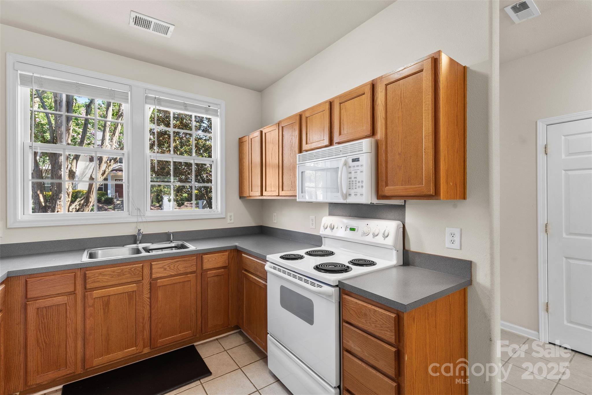 6320 Rhodins Lane Fort Mill, SC 29707 - Photo 7 of 33 a kitchen with stainless steel appliances granite countertop a sink stove and cabinets