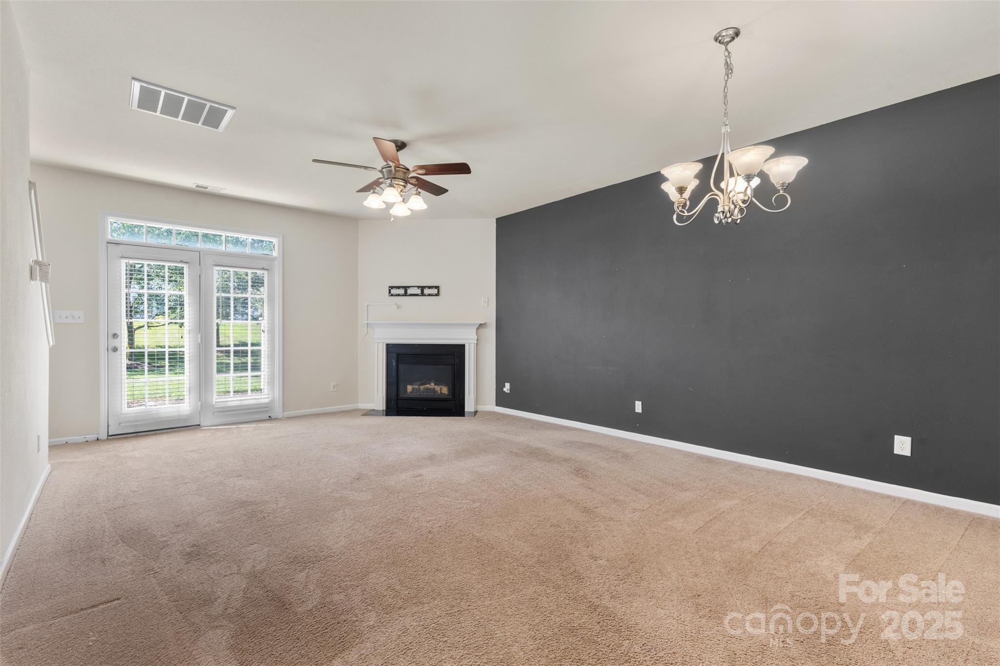 6320 Rhodins Lane Fort Mill, SC 29707 - Photo 9 of 33 a view of a room with a ceiling fan and a chandelier fan