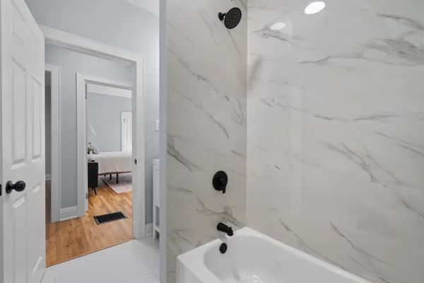 a bathroom with a tub and shower