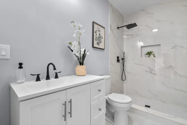 a bathroom with a toilet sink and shower