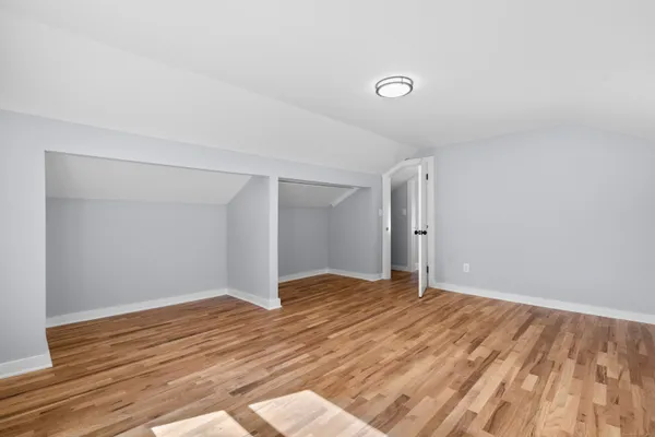a view of an empty room and wooden floor