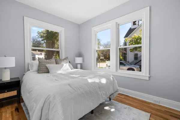 a bedroom with a bed and a window