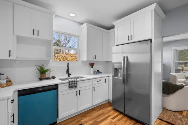 a kitchen with a sink stainless steel appliances and cabinets