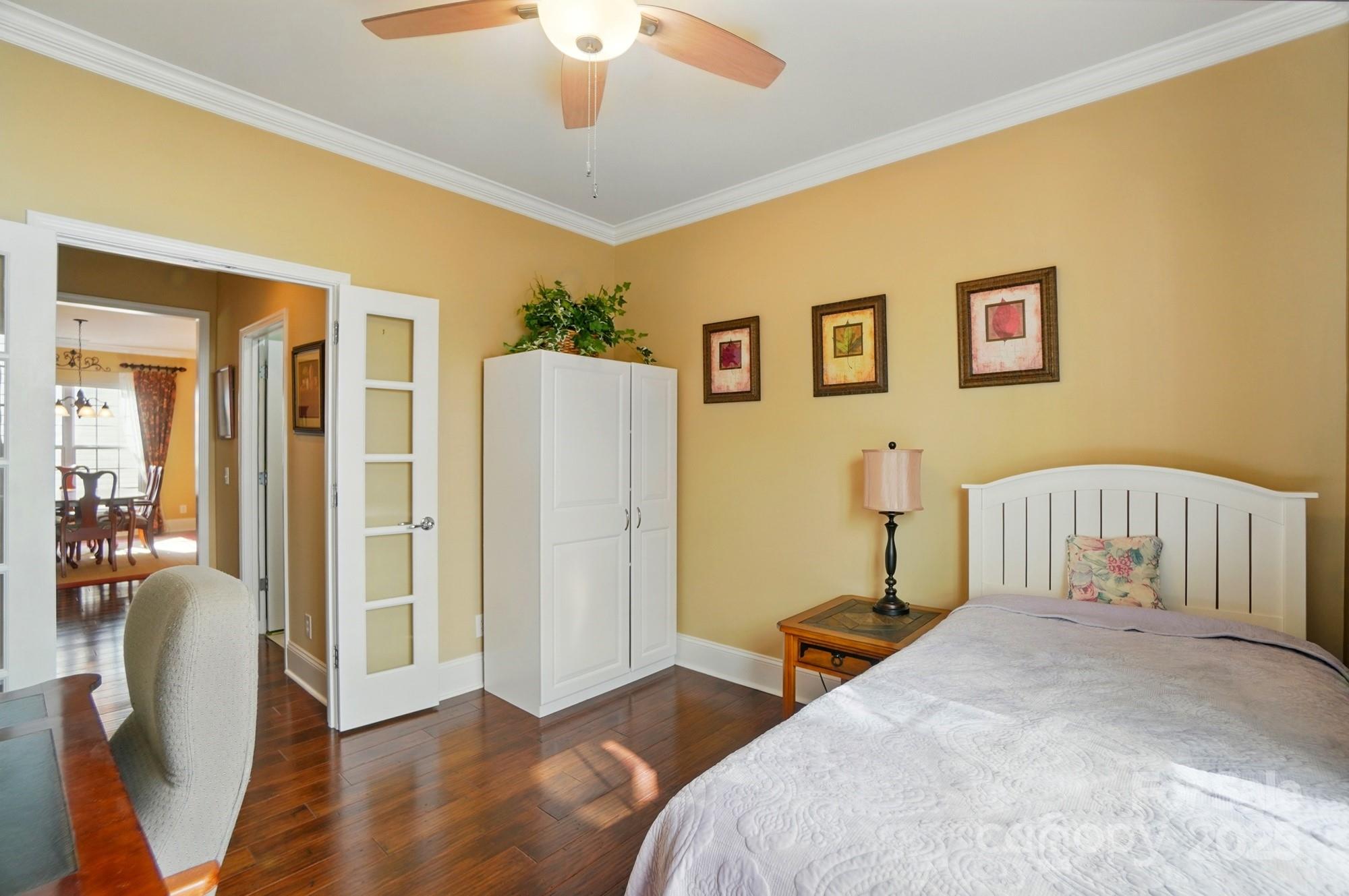 1974 Links View Drive Fort Mill, SC 29707 - Photo 21 of 30 a bedroom with furniture and a chandelier
