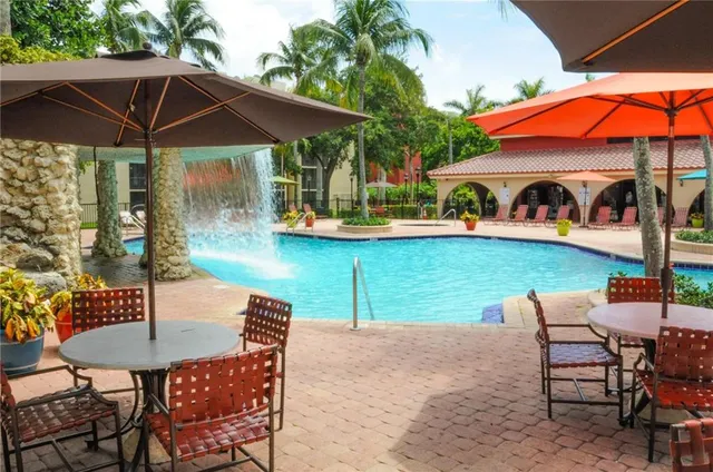 an outdoor space with furniture and umbrella