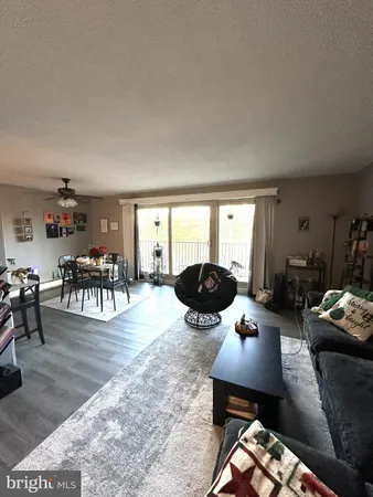 a living room with furniture a table and chairs