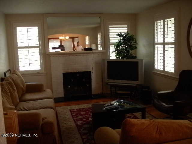 4135 Dover Road Jacksonville, FL 32207 - Photo 3 of 5 a living room with furniture a flat screen tv and a fireplace