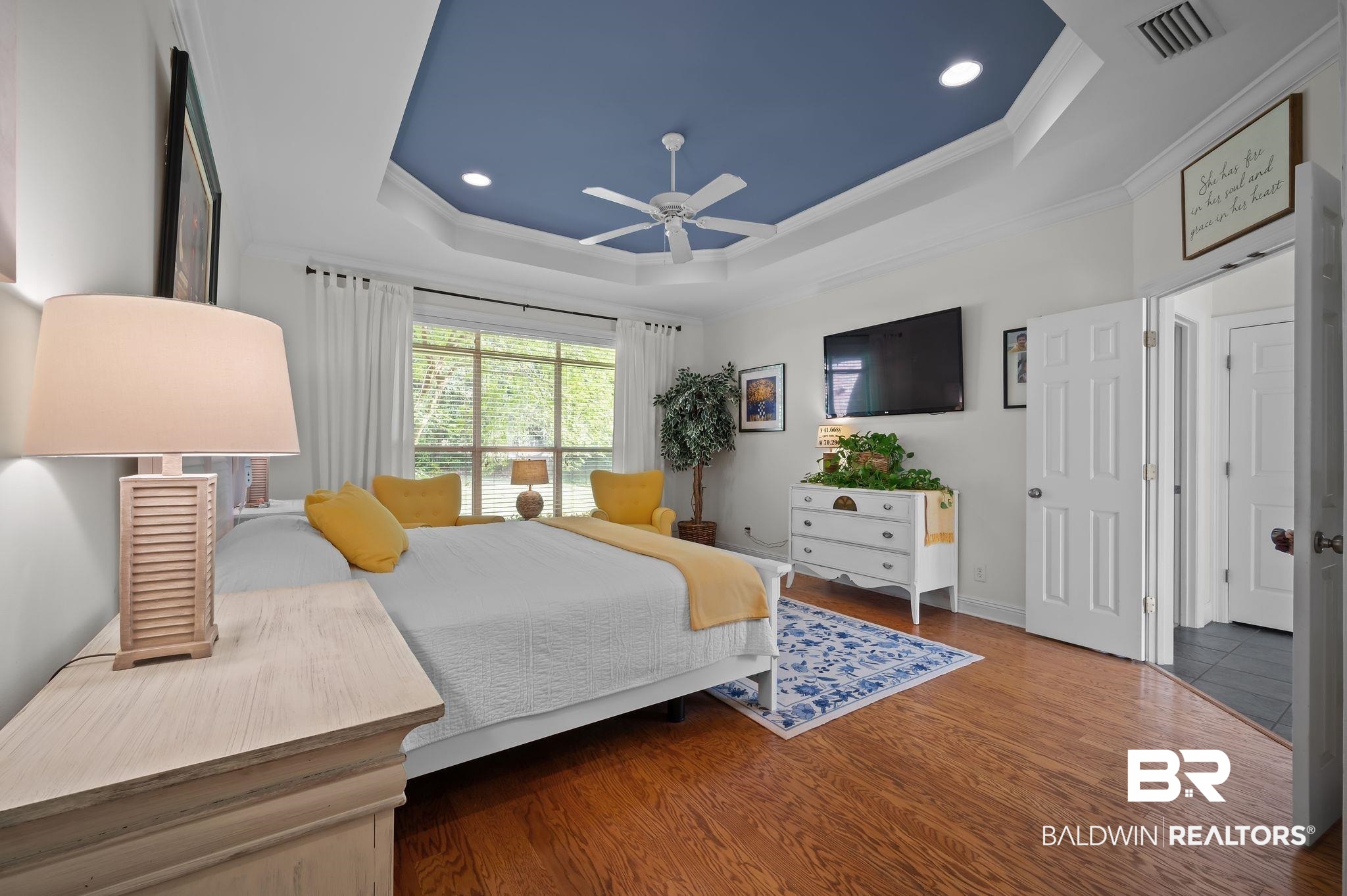 30151 Dolive Ridge Daphne, AL 36527 - Photo 14 of 37 Bedroom featuring recessed lighting, a tray ceiling, visible vents, ornamental molding, and wood finished floors