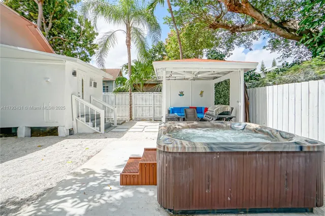 a building outdoor space with patio furniture and potted plants