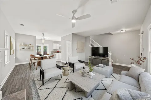 a view of a hallway with wooden floor and stairs