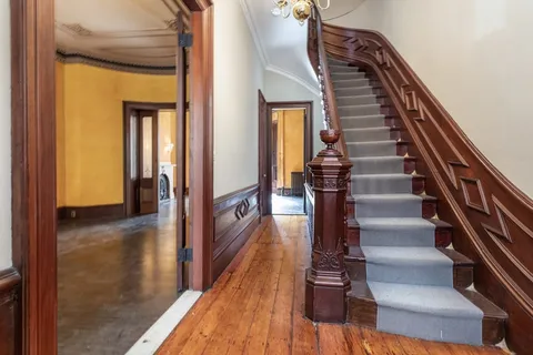 a view of entryway and hall with wooden floor