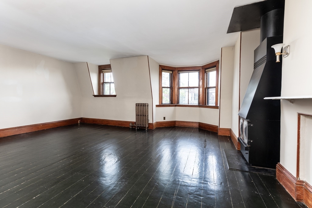 56 Rutland Square Boston, MA 02118 - Photo 20 of 28 an empty room with wooden floor and windows