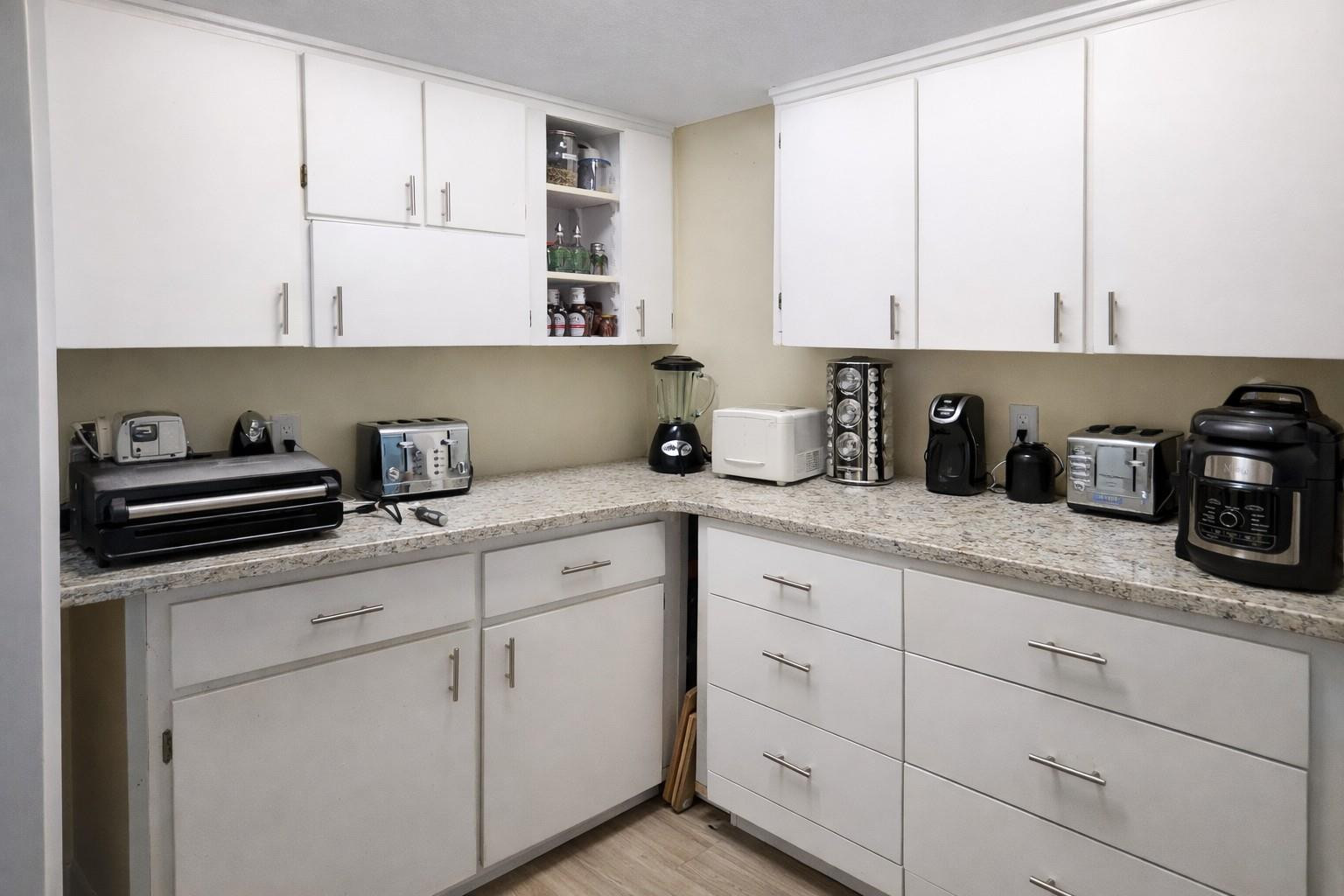 728 North Fischer Circle Sebastian, FL 32958 - Photo 3 of 23 a kitchen with white cabinets and appliances