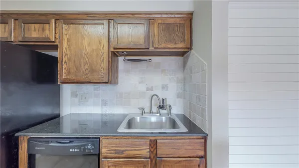 a kitchen with granite countertop a sink and a stove