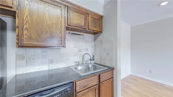 a kitchen with a sink cabinets and stainless steel appliances