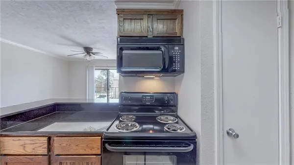 a room with a stove and a microwave