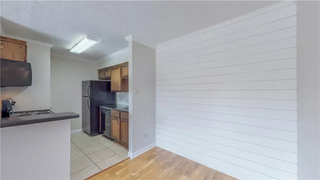 a kitchen with stainless steel appliances granite countertop a refrigerator and a stove top oven