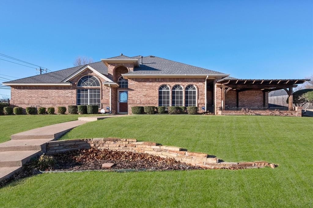 a front view of a house with a garden and plants