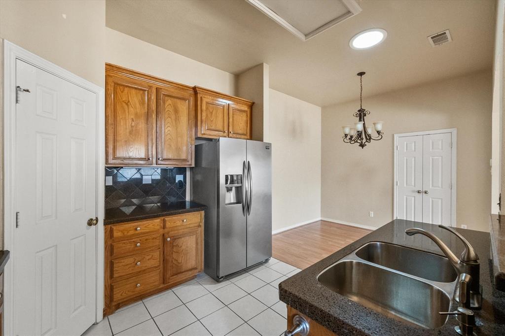 2327 Ragland Road Mansfield, TX 76063 - Photo 14 of 31 a kitchen with granite countertop a refrigerator and a sink