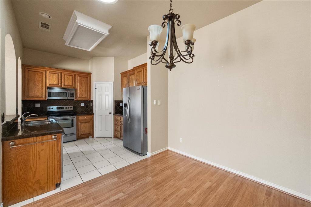 2327 Ragland Road Mansfield, TX 76063 - Photo 16 of 31 a kitchen with a refrigerator a stove top oven a sink and dishwasher