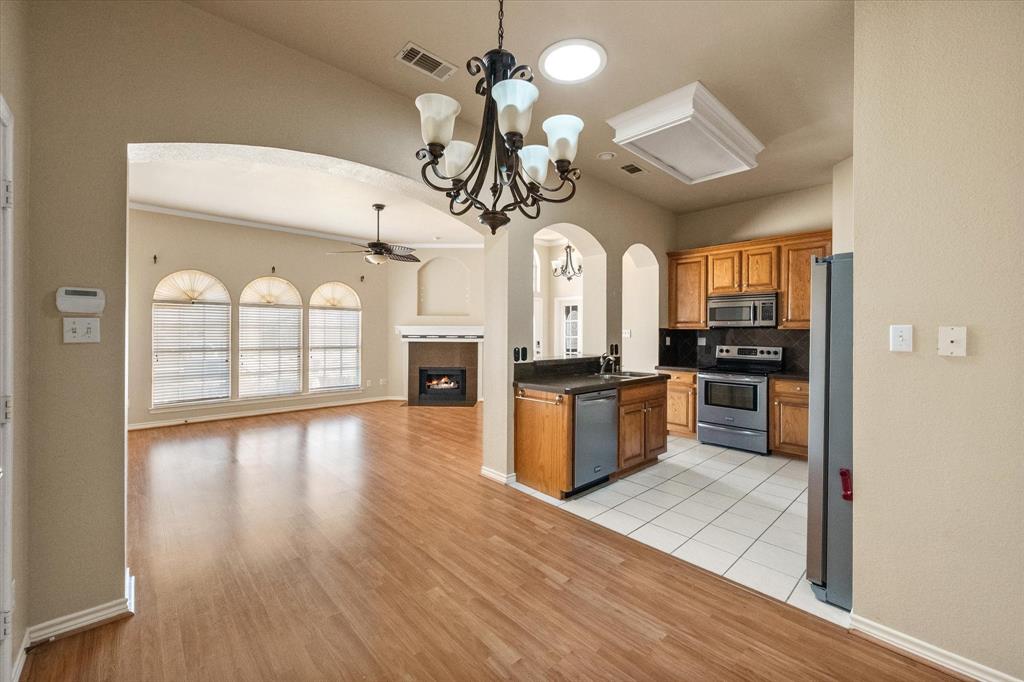 2327 Ragland Road Mansfield, TX 76063 - Photo 17 of 31 a view of a kitchen with a sink wooden floor and cabinets