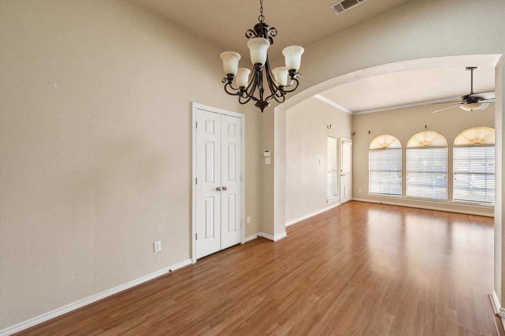 2327 Ragland Road Mansfield, TX 76063 - Photo 18 of 31 a view of a room with wooden floor chandelier and windows