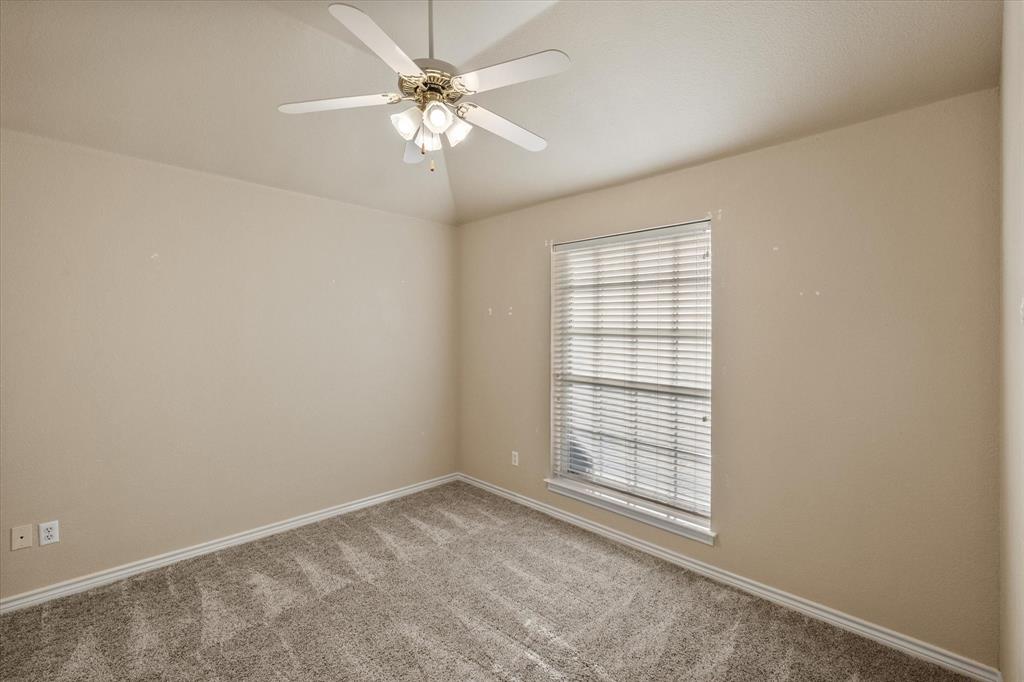 2327 Ragland Road Mansfield, TX 76063 - Photo 21 of 31 an empty room with a chandelier fan and windows