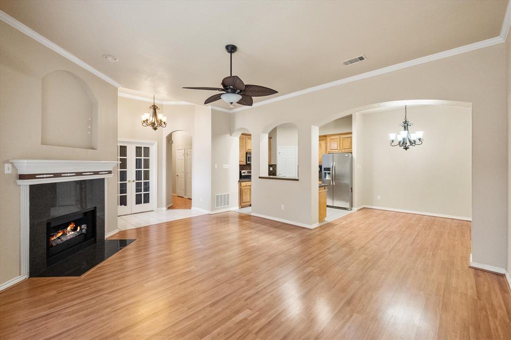 2327 Ragland Road Mansfield, TX 76063 - Photo 8 of 31 a view of an empty room with wooden floor fireplace and a window