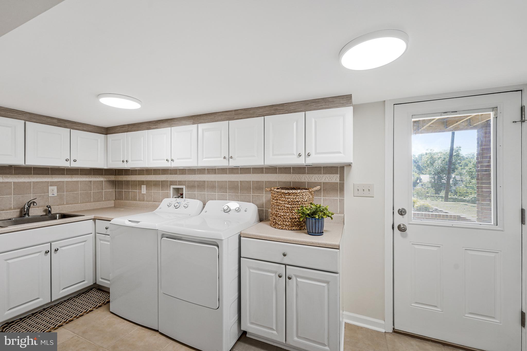 5801 Boothe Drive Burke, VA 22015 - Photo 22 of 30 a utility room with cabinets washer and dryer