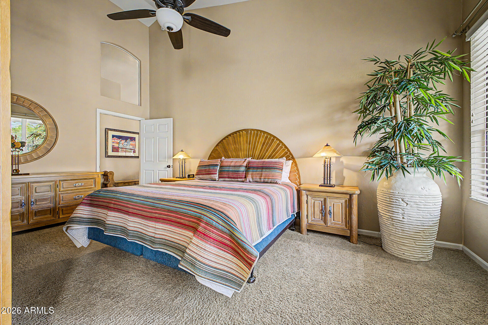 4309 East Rancho Caliente Drive Cave Creek, AZ 85331 - Photo 15 of 37 a spacious bedroom with a bed and a potted plant