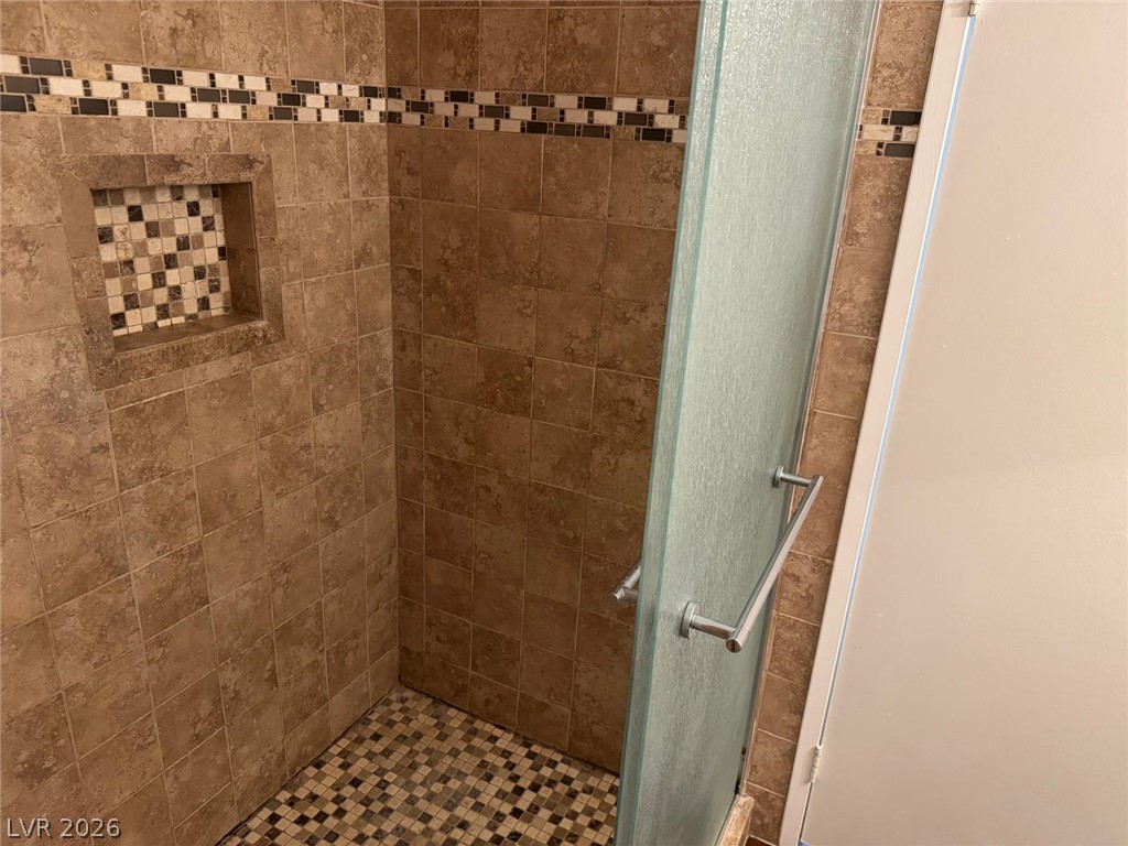 7885 West Flamingo Road, Unit 2171 Las Vegas, NV 89147 - Photo 15 of 22 A well-appointed shower with elegant tilework and a glass enclosure offers a refreshing start to your day.