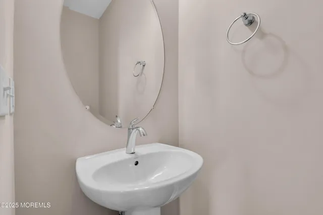 a bathroom with a sink and mirror