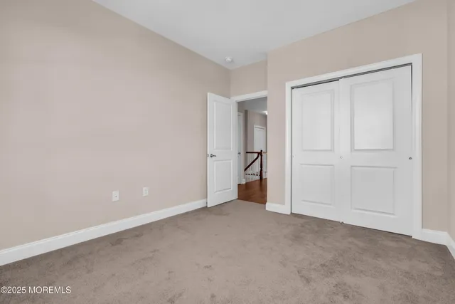a view of an empty room and closet area