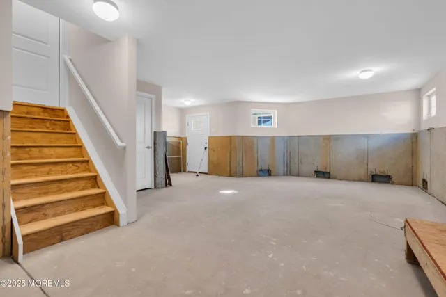 a view of a livingroom with wooden floor and stairs