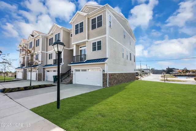 a view of a house with a yard and sitting area