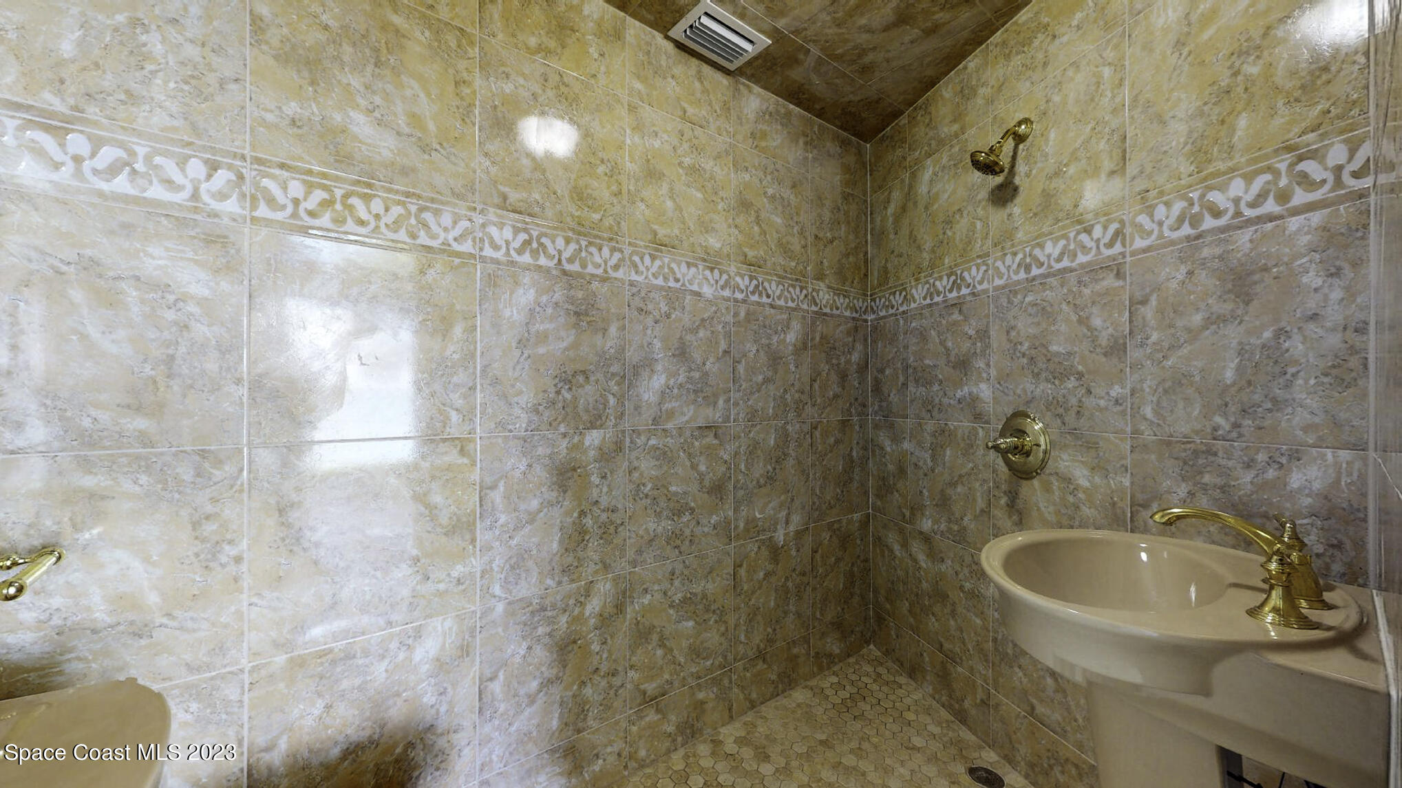 21 West Point Drive, Unit 101 Cocoa Beach, FL 32931 - Photo 11 of 59 a bathroom with a sink and a mirror