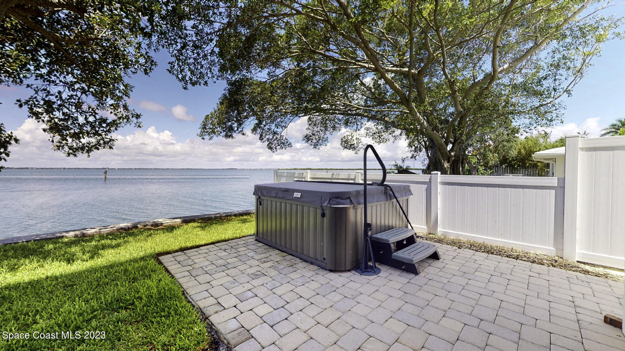 21 West Point Drive, Unit 101 Cocoa Beach, FL 32931 - Photo 14 of 59 a view of a swimming pool with an outdoor seating and a yard