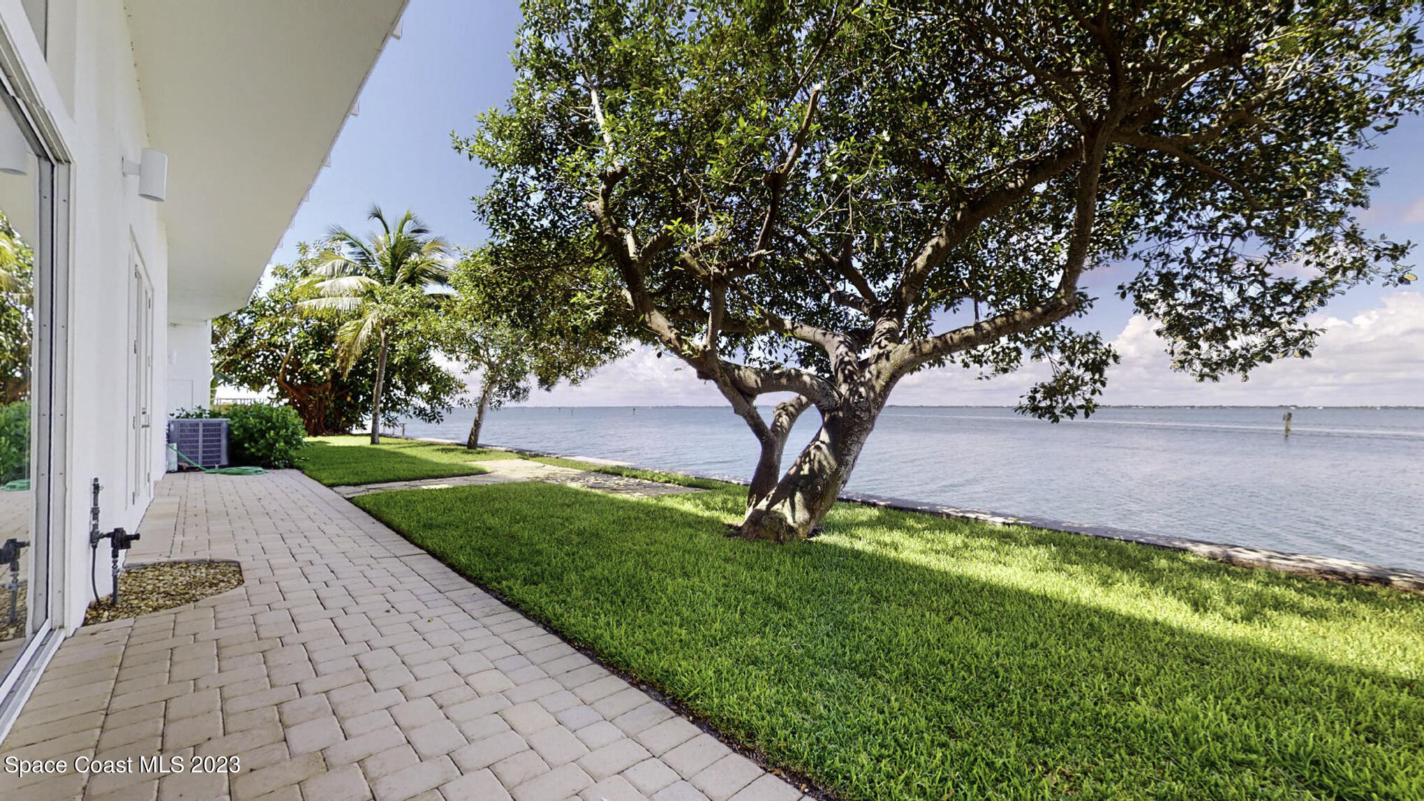 21 West Point Drive, Unit 101 Cocoa Beach, FL 32931 - Photo 15 of 59 a view of a yard with a tree