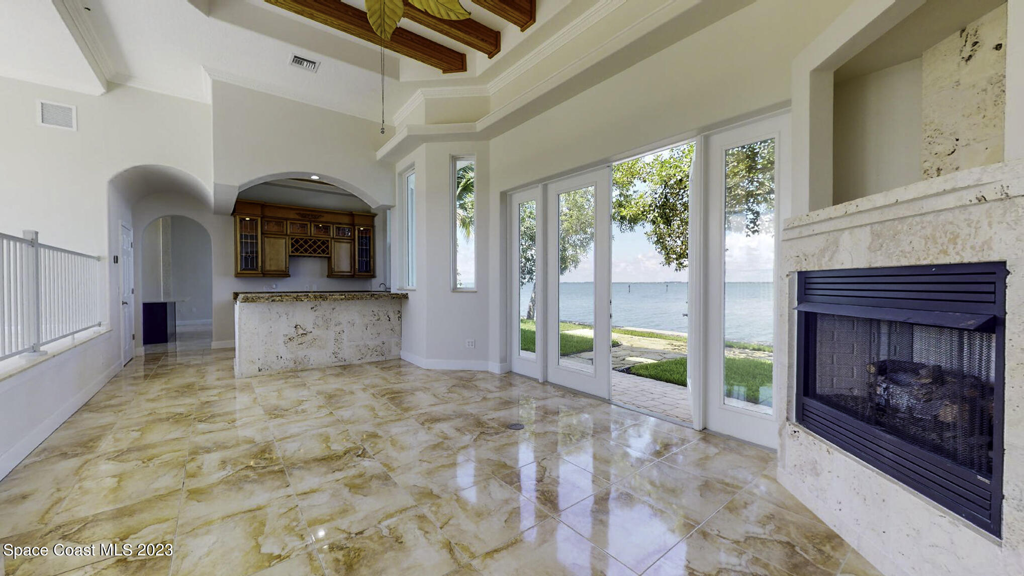 21 West Point Drive, Unit 101 Cocoa Beach, FL 32931 - Photo 16 of 59 a large bedroom with a bed and a fireplace